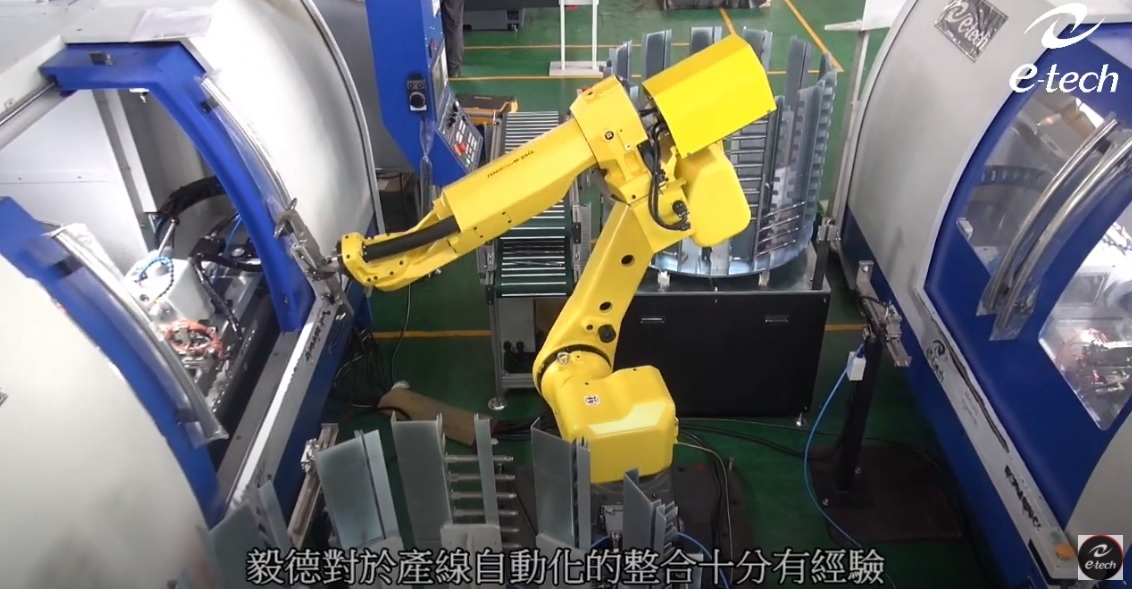Cylindrical grinding machine with robot arm